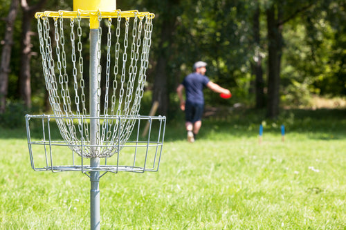 Rhino Skin Solutions partnered with the Disc Golf Pro Tour to support players — disc golfer mid-throw showing peak performance, endurance, and skin protection.