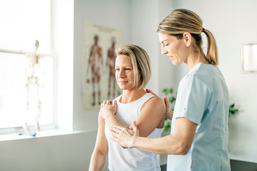Physical therapist treating a shoulder — Rhino muscle and joint care.