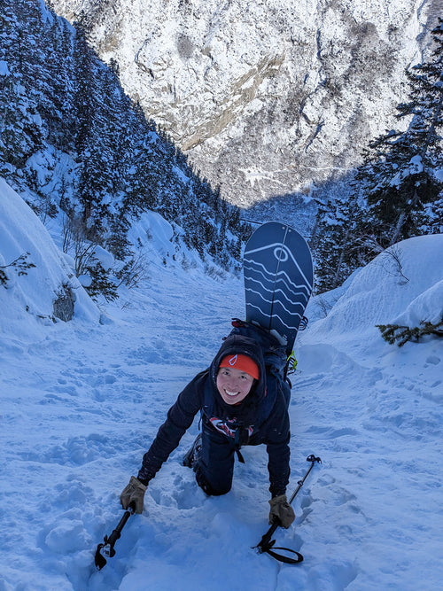 Skier descending a steep snow chute — Rhino skin care for winter athletes.