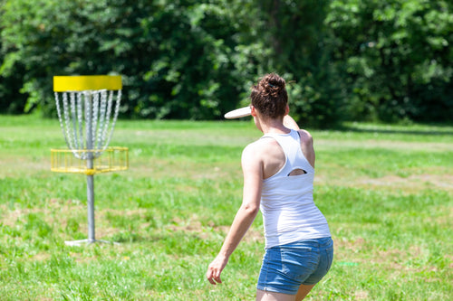 Professional disc golfer lining up a putt during a DGPT event, hands protected with Rhino Skin Solutions — trusted skincare for disc golfers and outdoor athletes