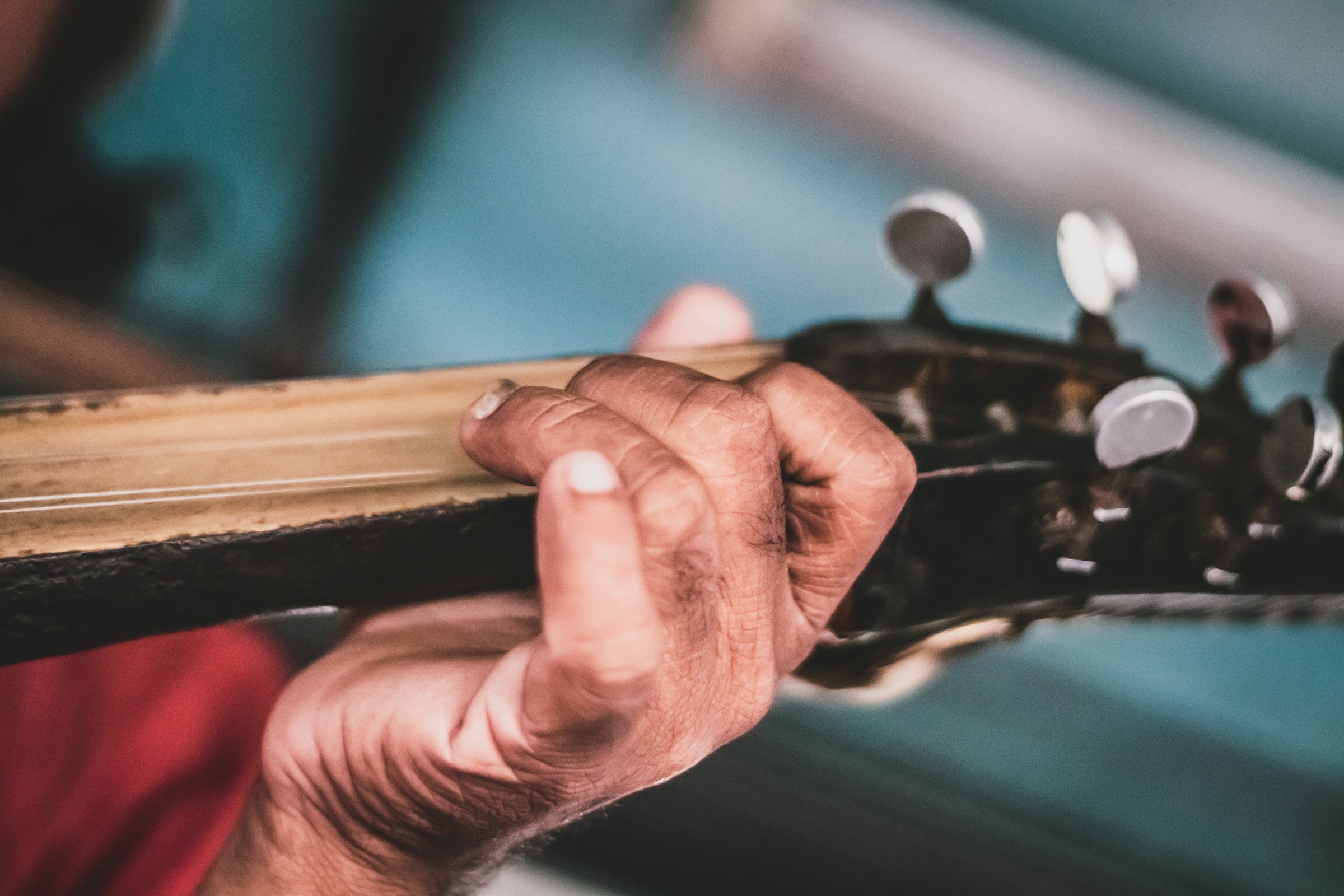 Guitarist's fingers on the fretboard — fingertip care for musicians