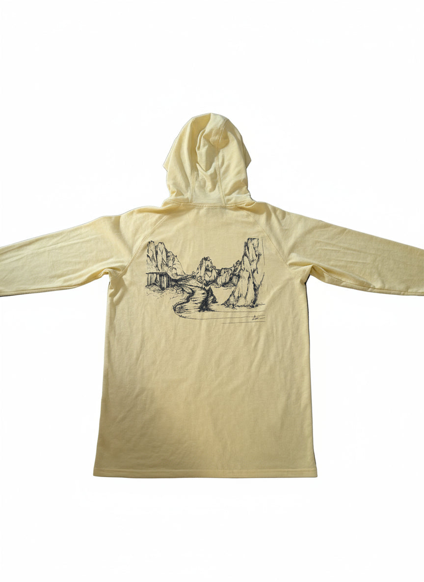 Yellow hoodie with a graphic design on a wooden surface
