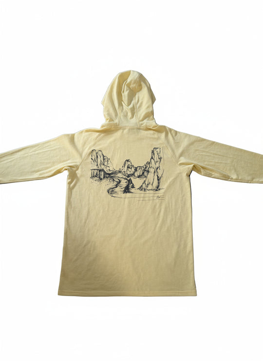 Yellow hoodie with a graphic design on a wooden surface
