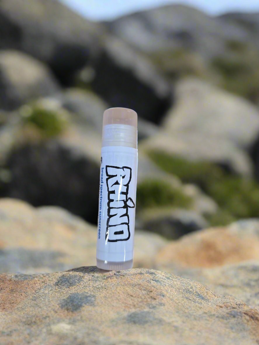 Close-Up of Lip Balm Tube:
"Close-up of Reef Safe SPF 15 Zinc Lip Balm by Rhino Skin Solutions, showcasing natural and organic ingredients like zinc oxide and cacao butter."