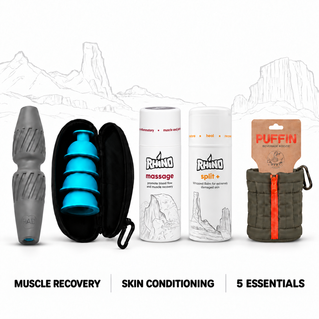 A bundle of five muscle recovery and skin conditioning essentials arranged on a white background with faint mountain line art. From left to right: a gray textured massage tool, an open black zip case holding bright blue silicone pieces, two white Rhino-branded bottles labeled massage and split+, and a brown Puffin branded pouch with an orange zipper.