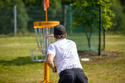Disc golf pro throwing during DGPT competition, using Rhino Skin Solutions to protect and heal skin for peak disc golf performance