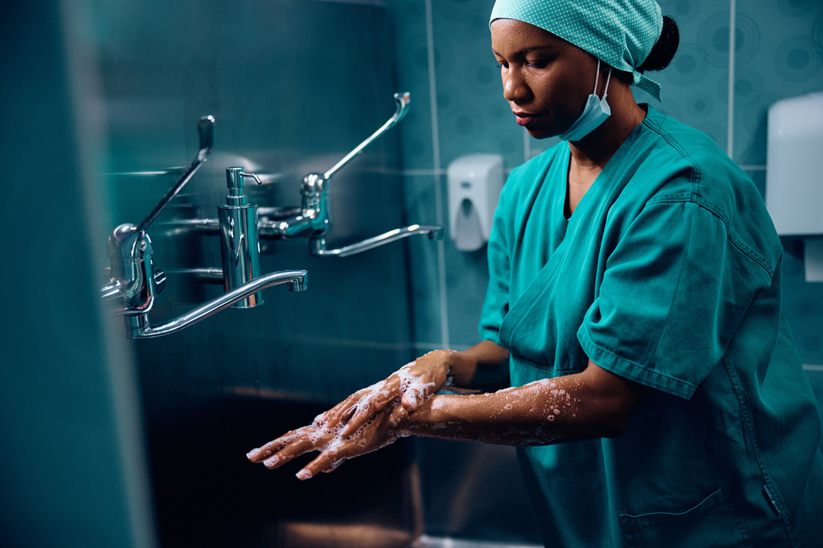 Healthcare worker washing hands — Rhino skin care for hardworking hands.
