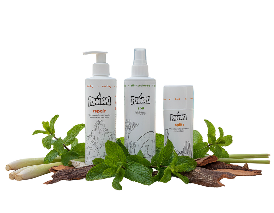 Three Rhino skincare products on a beach with greenery and water in the background