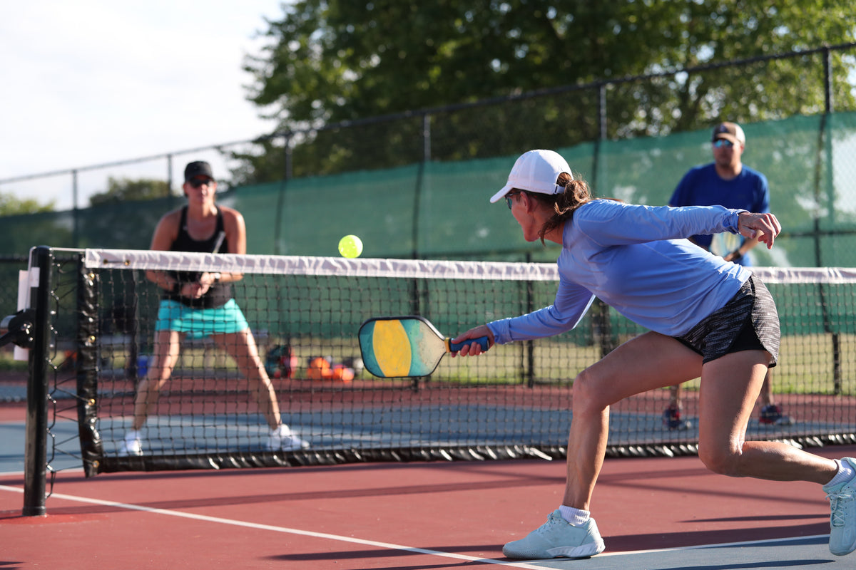 Pickleball players mid-game — Rhino skin care for racquet sports.