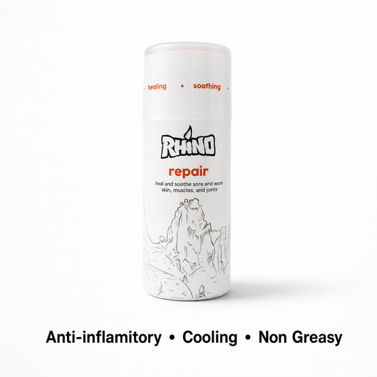 A white cylindrical canister of Rhino Repair cream with orange and black text, shown on a white background with the text &