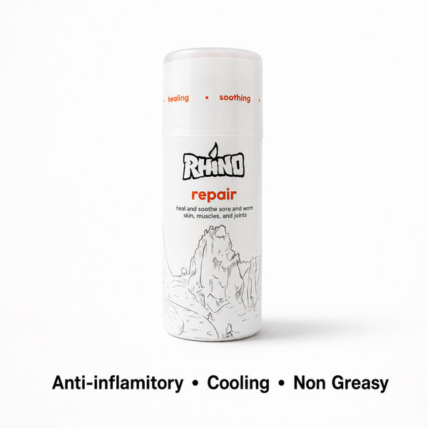 A white cylindrical canister of Rhino Repair cream with orange and black text, shown on a white background with the text 'Anti-inflammatory • Cooling • Non Greasy' underneath.