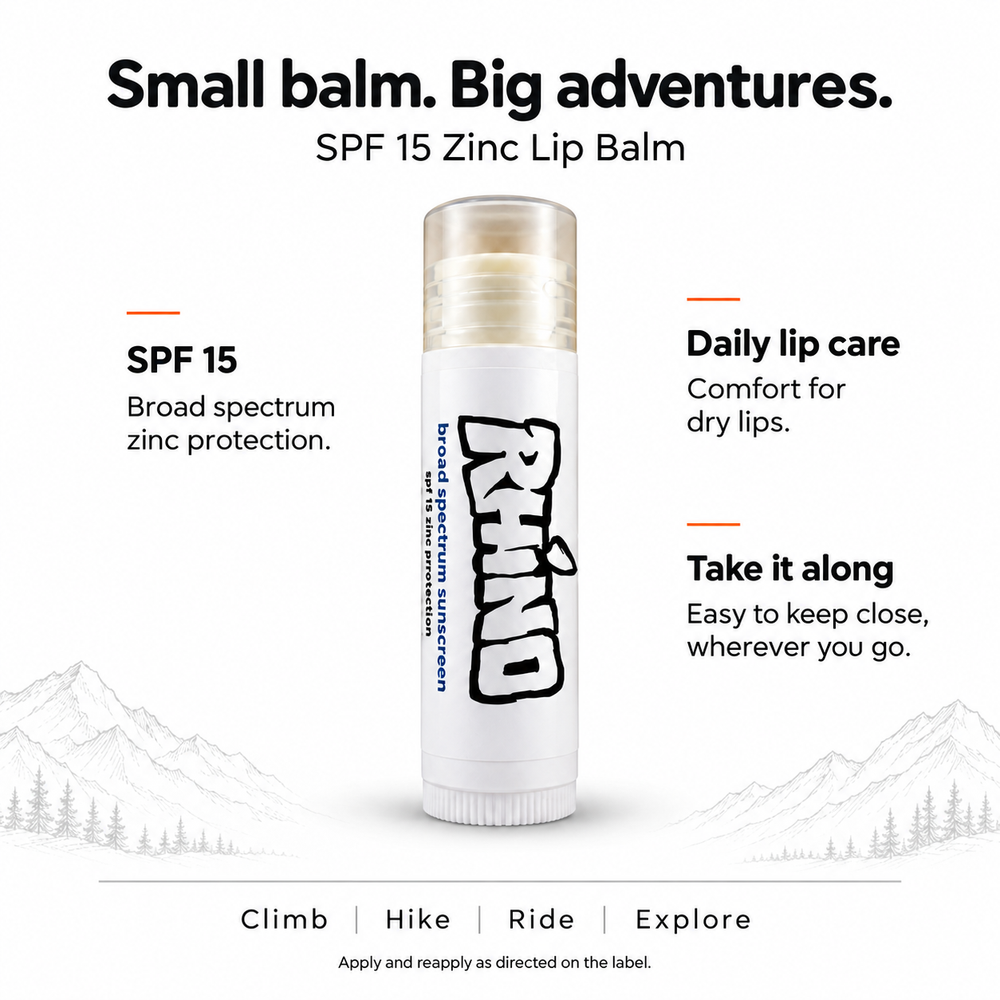 A single tube of lip balm centered on a white background with marketing text around it. The product is labeled 'SPF 15 Zinc Lip Balm' and has a mostly white tube with black and gray branding.
