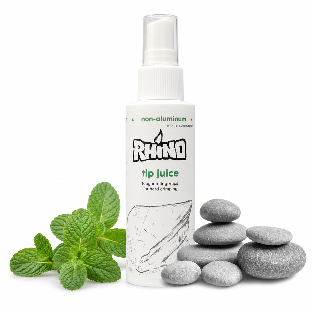 Rhino tip juice bottle with mint leaves and stones on a white background