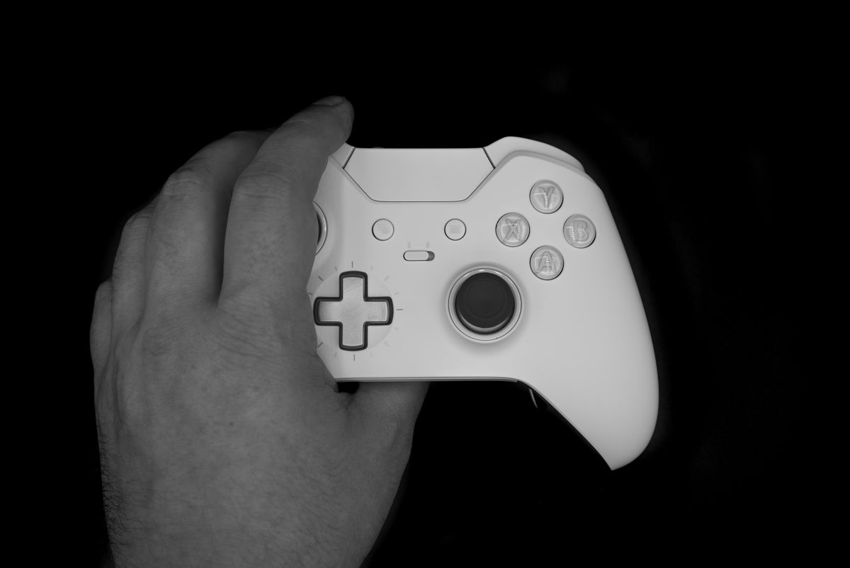Hand grabbing a gaming controller — Rhino skin care for gamers.