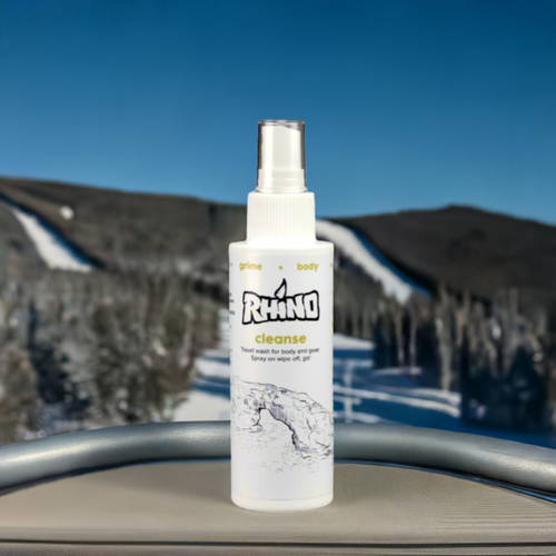 Rhino Cleanse spray bottle on a ski chairlift seat — quick skin refresh for winter sports.