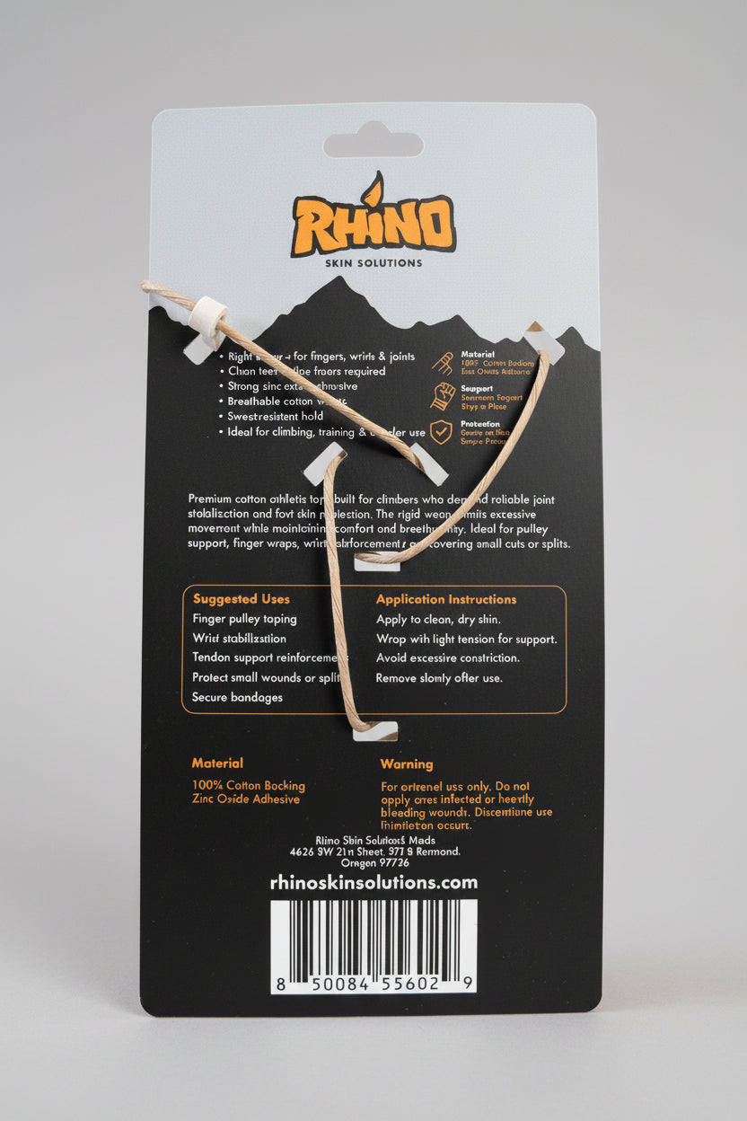 A Rhino Kinesiology tape set with white tape and a black-and-white branded backing card, photographed on a wooden surface with a plastic storage container in the background.